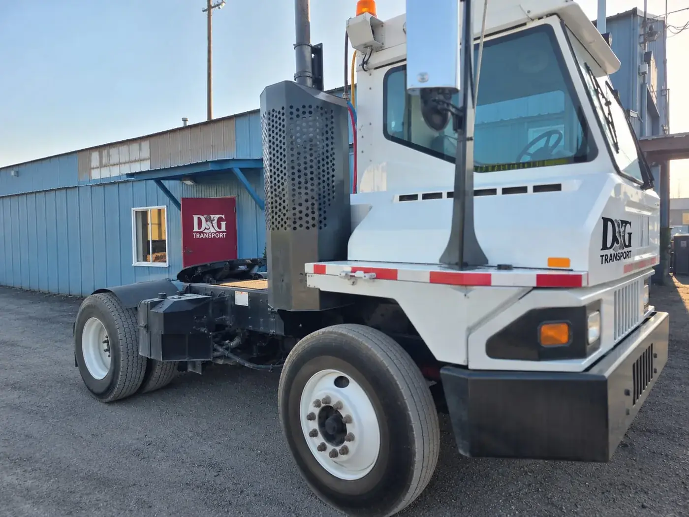 White D&G Transport yard hostler parked outside the company shop building in the Tacoma yard