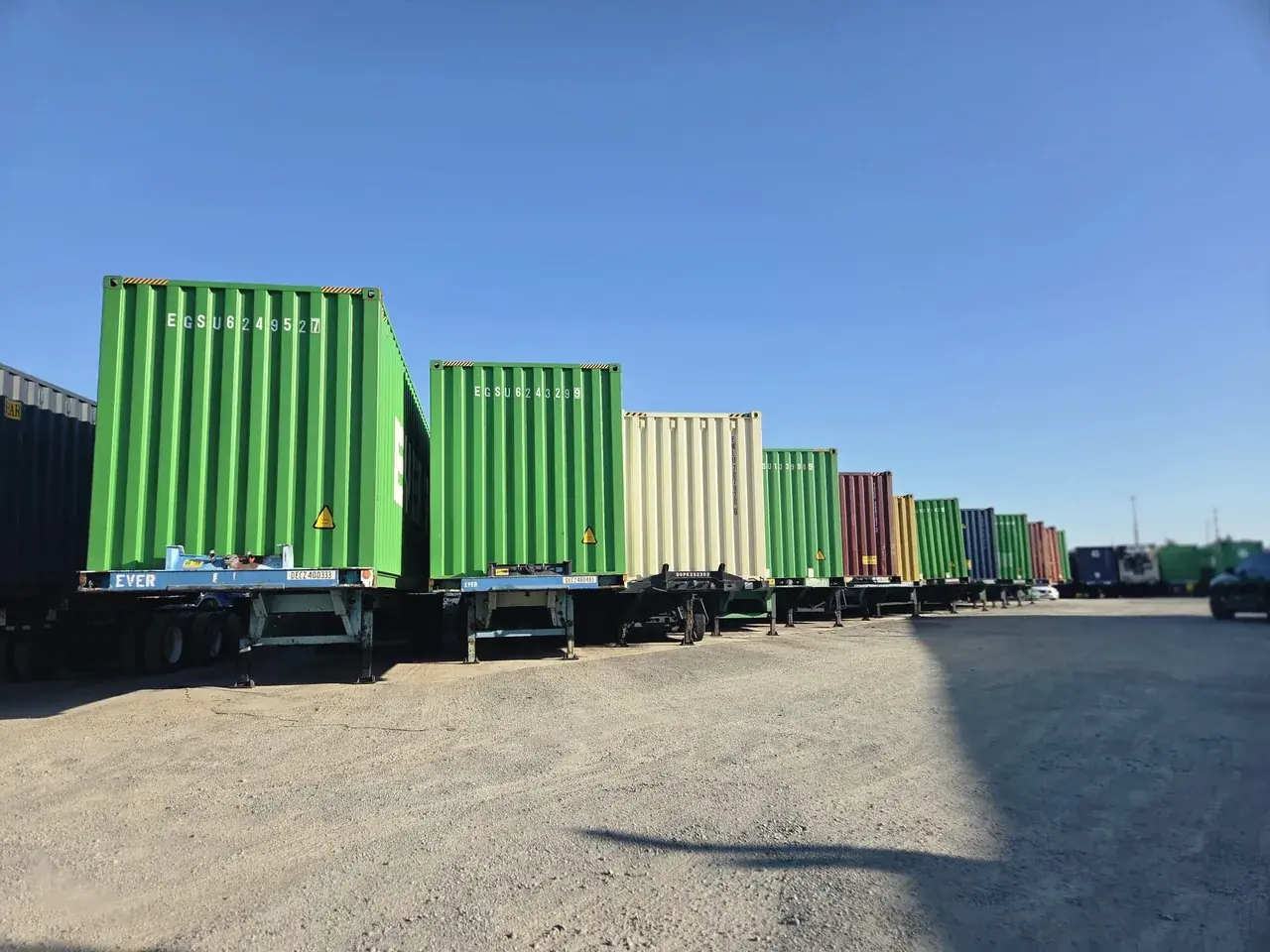 Containers staged on chassis in a long row at the D&G Transport yard